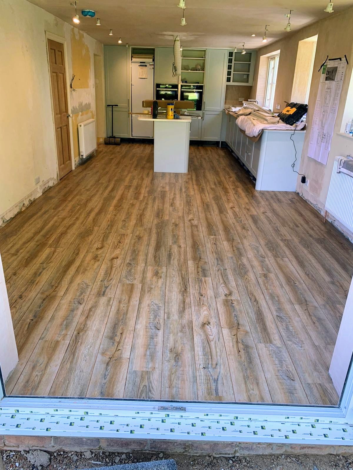 All Aspect Flooring; Luxury Vinyl Tile Installation with Ship Deck Effect in a Kitchen Diner.